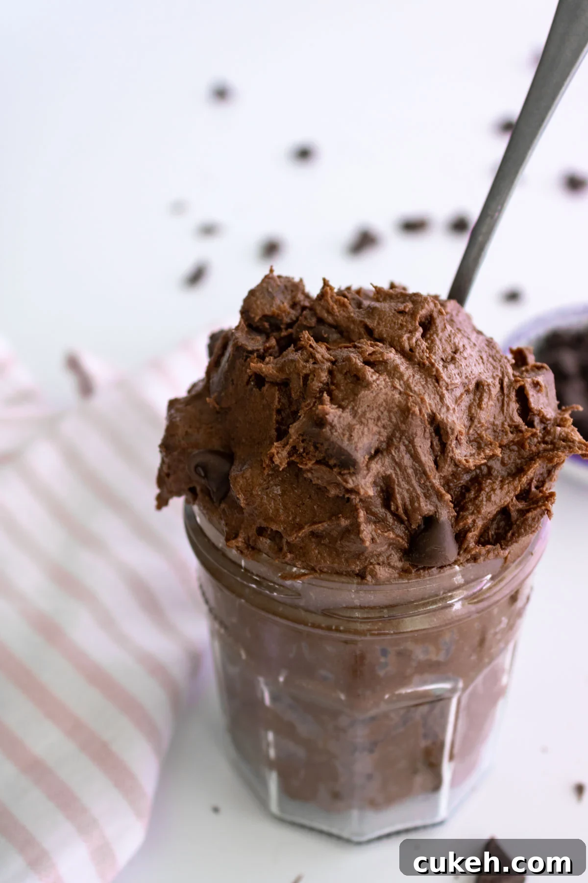 How to Make Safe Edible Brownie Batter at Home 2 edible brownie batter in a jar with a spoon.