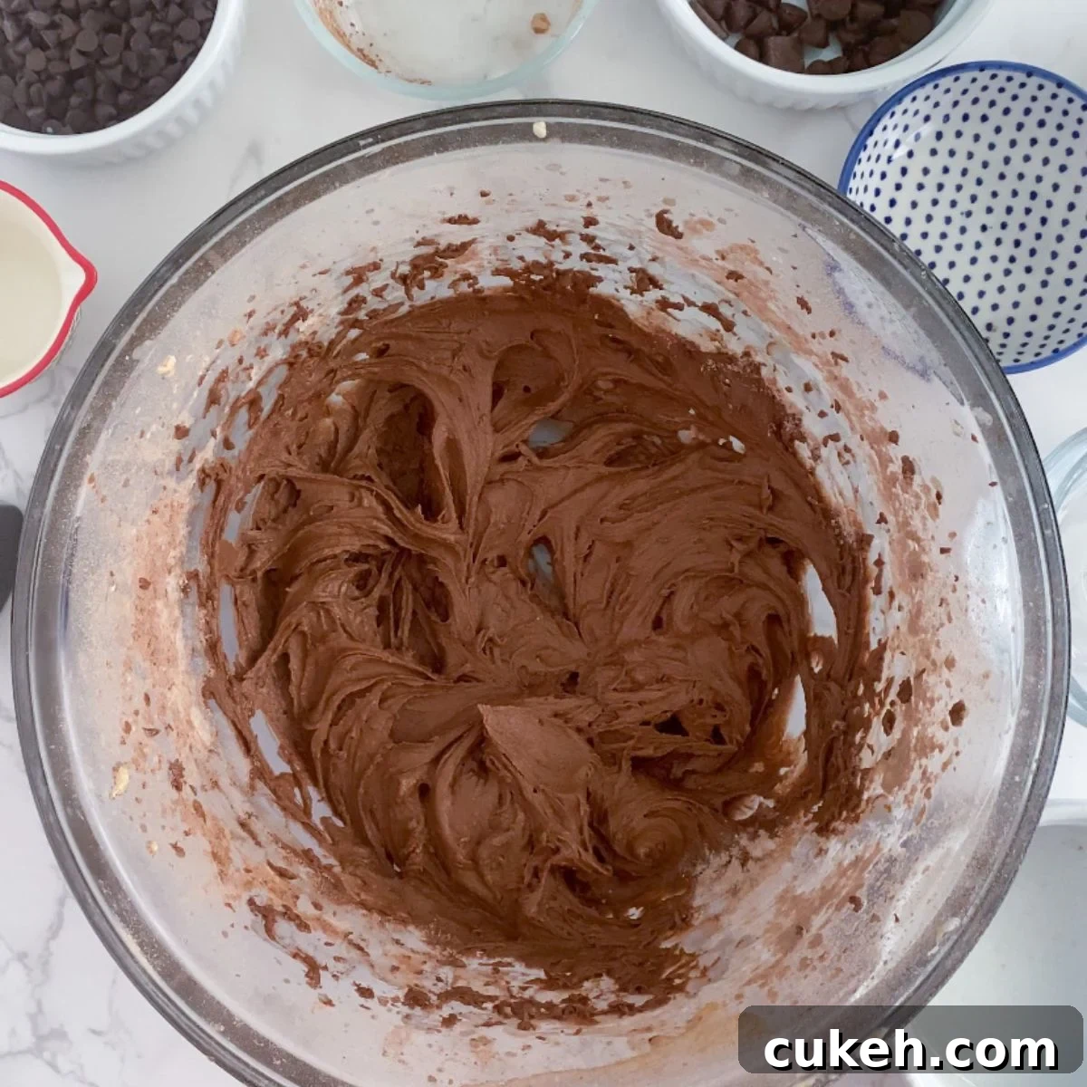 How to Make Safe Edible Brownie Batter at Home 6 milk, sugar, butter, vanilla, flour, salt and cocoa powder combined in a bowl.