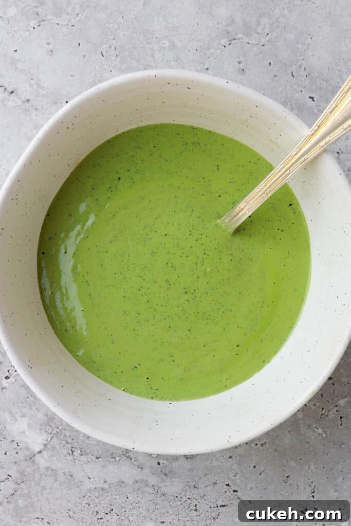 Green herb tahini sauce in a bowl.