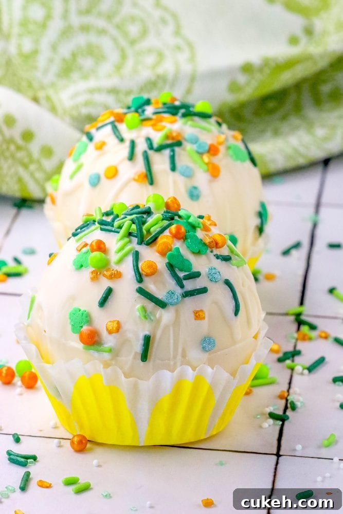Saint Patrick's Day Hot Chocolate Bombs Recipe: Festive Ideas & Tips 4 white chocolate hot chocolate bombs covered in saint patricks day sprinkles on a table