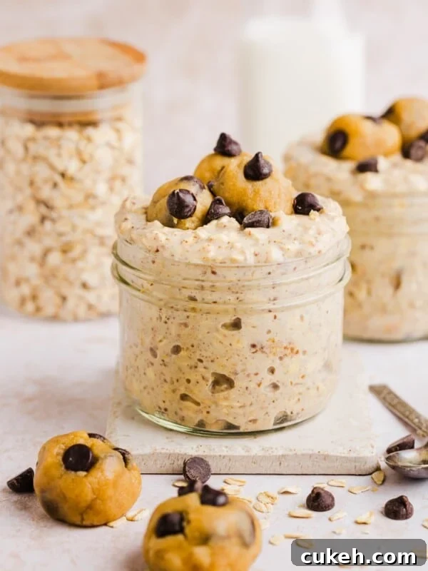 Cookie dough overnight oats with protein in a glass jar, topped with chocolate chips.