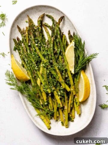 roasted asparagus on platter with lemon garnish