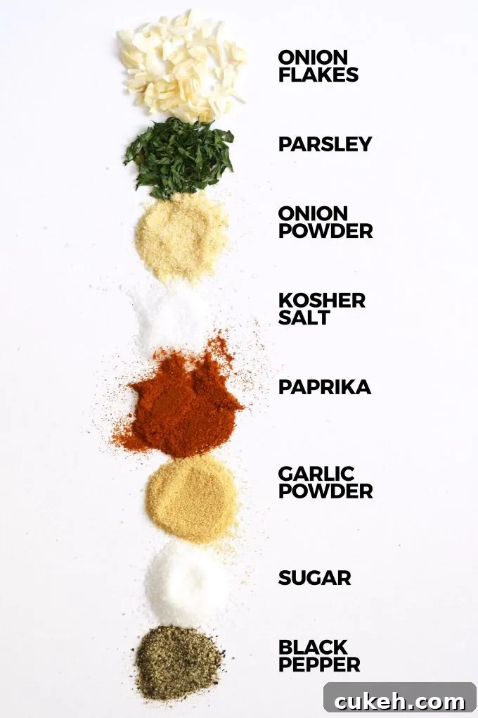 homemade onion soup mix ingredients on a white board with the ingredients labeled in black text to the right of the spices