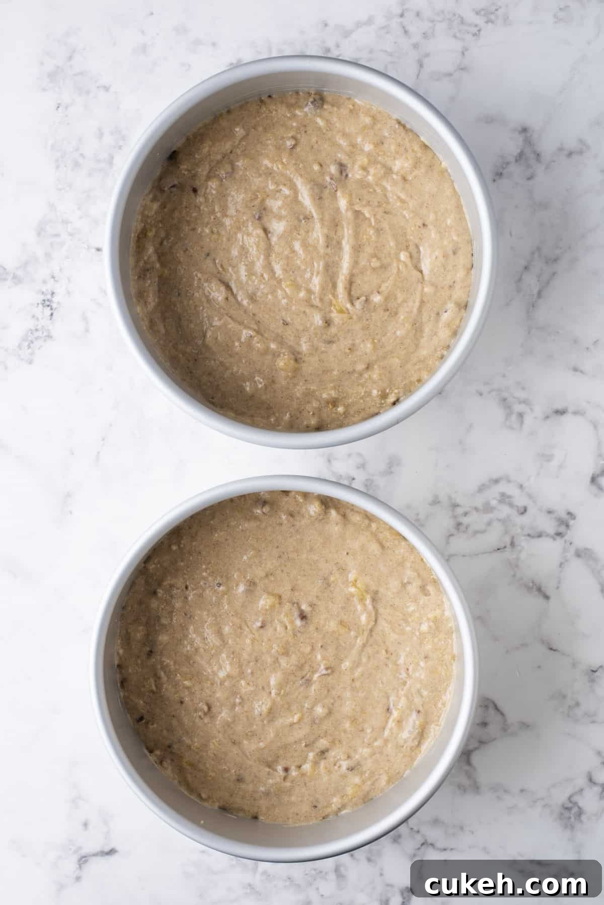 two round cake pans full of hummingbird cake batter