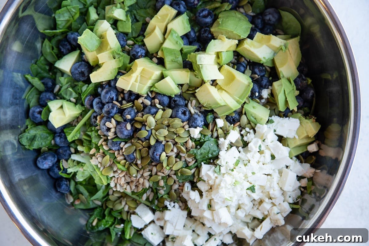 Salad ingredients in a large mixing bowl, ready to be tossed with salad dressing.