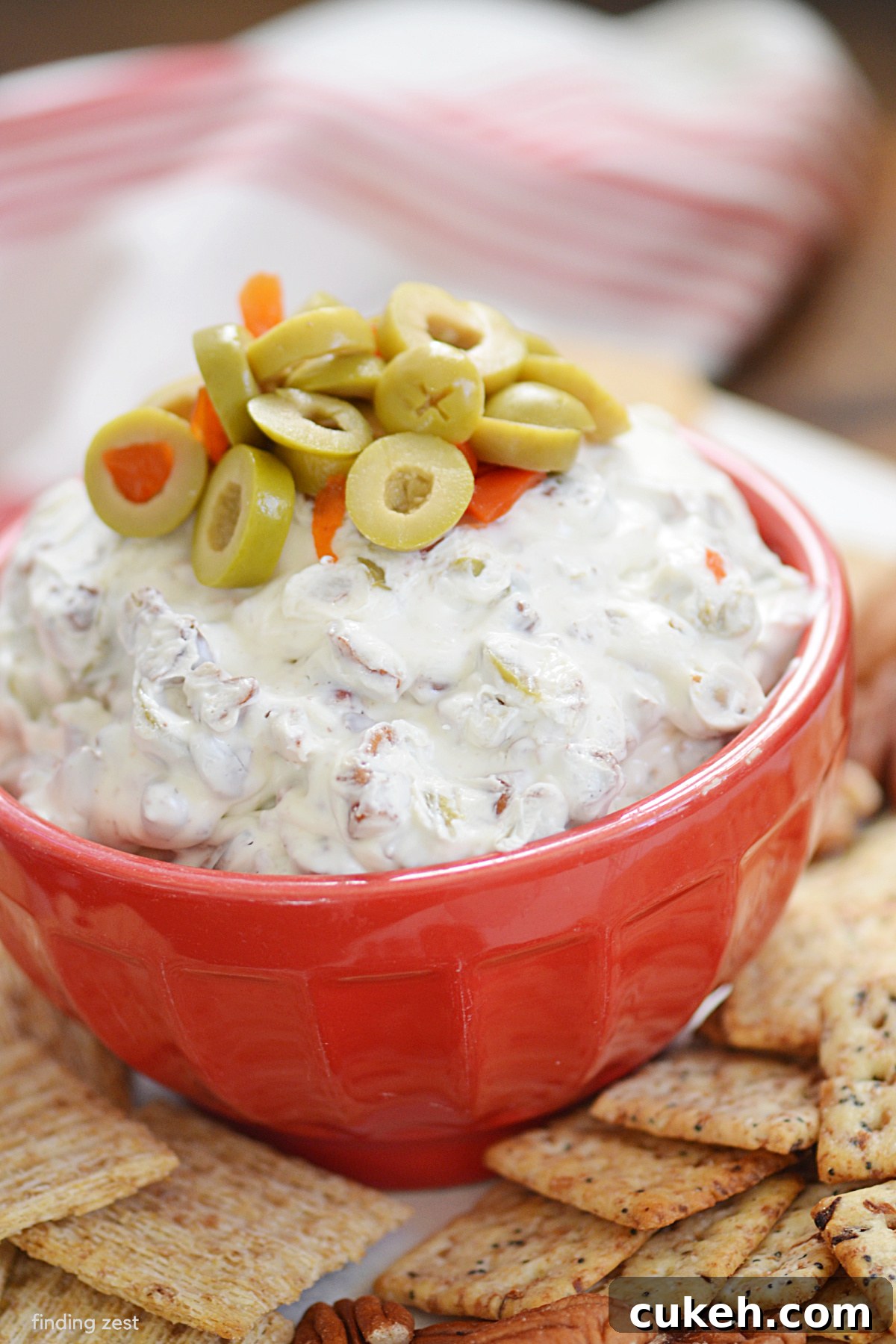 Olive dip is the ultimate party dip recipe! Made with just four ingredients including sliced green olives and chopped pecans, this dip is an easy appetizer that is always a hit! Serve it up with your favorite crackers, bread or veggies.