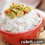 Olive dip is the ultimate party dip recipe! Made with just four ingredients including sliced green olives and chopped pecans, this dip is an easy appetizer that is always a hit! Serve it up with your favorite crackers, bread or veggies.