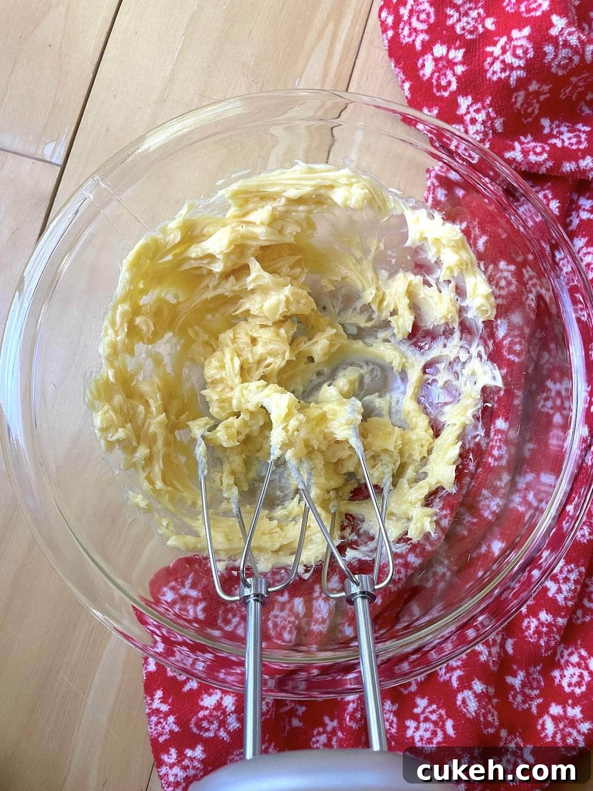 Honey butter in a mixing bowl after being whipped with a hand mixer.