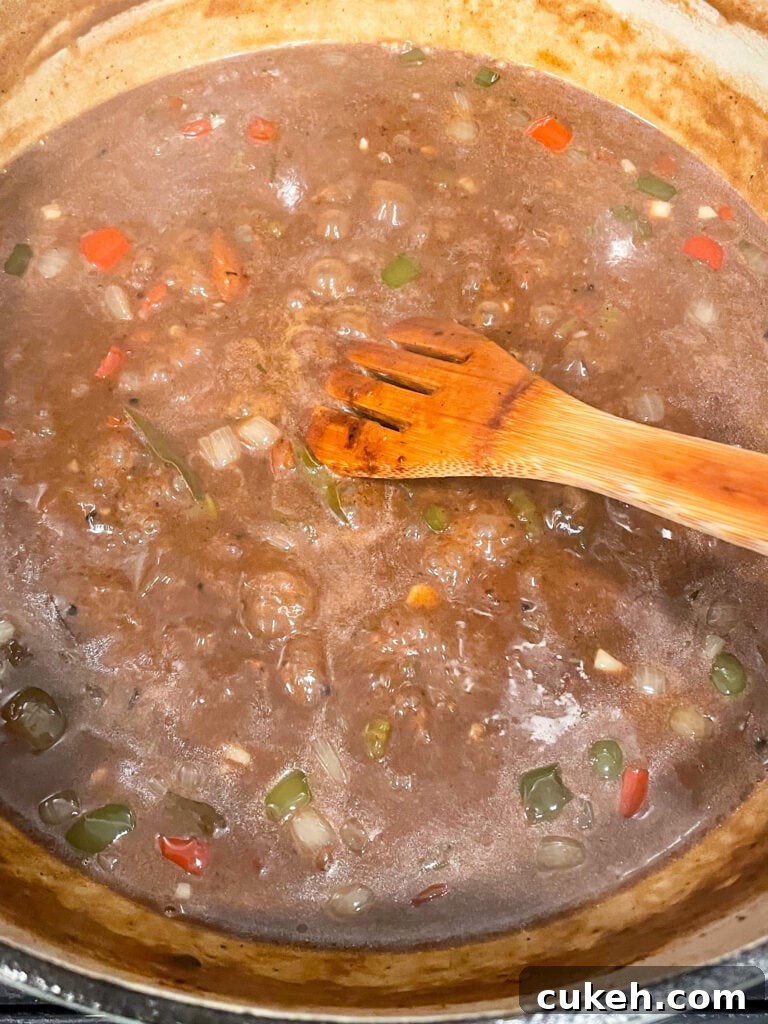 overhead shot of gumbo simmering in dutch oven before the chicken and sausage are added