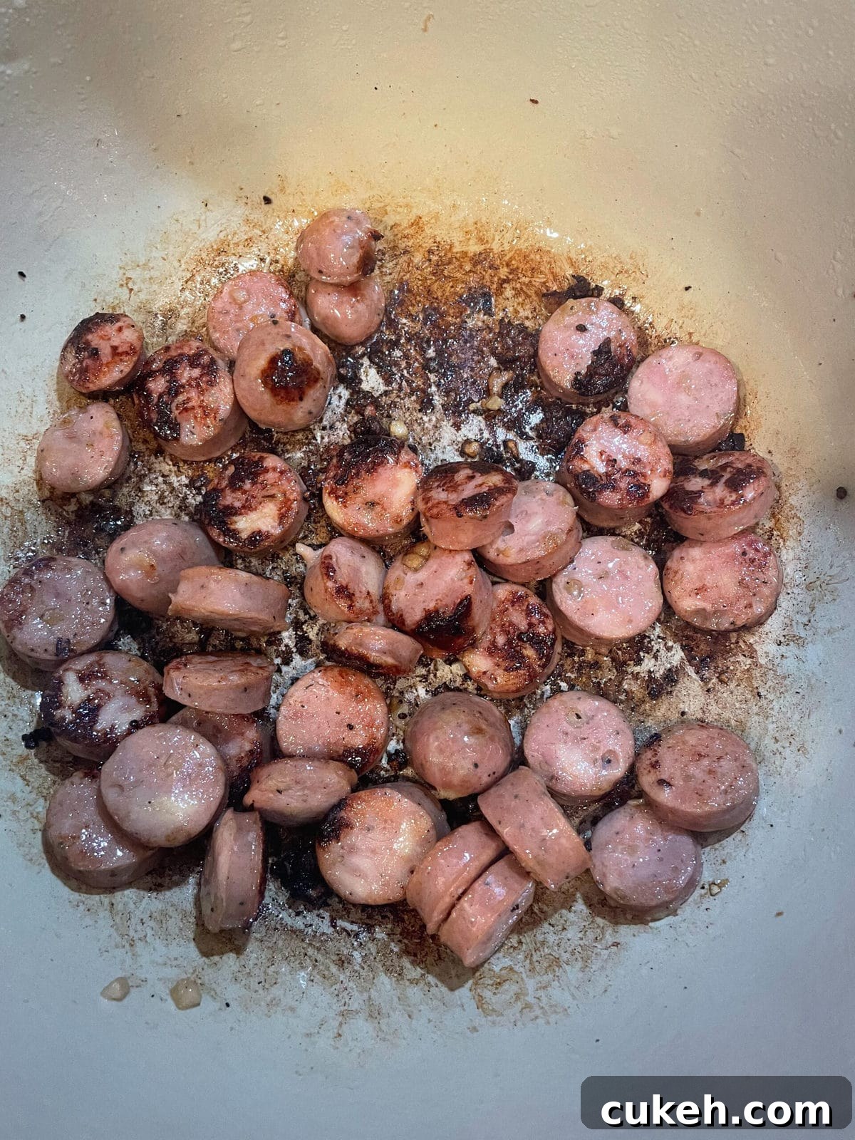 overhead shot of sausage cooking in dutch oven