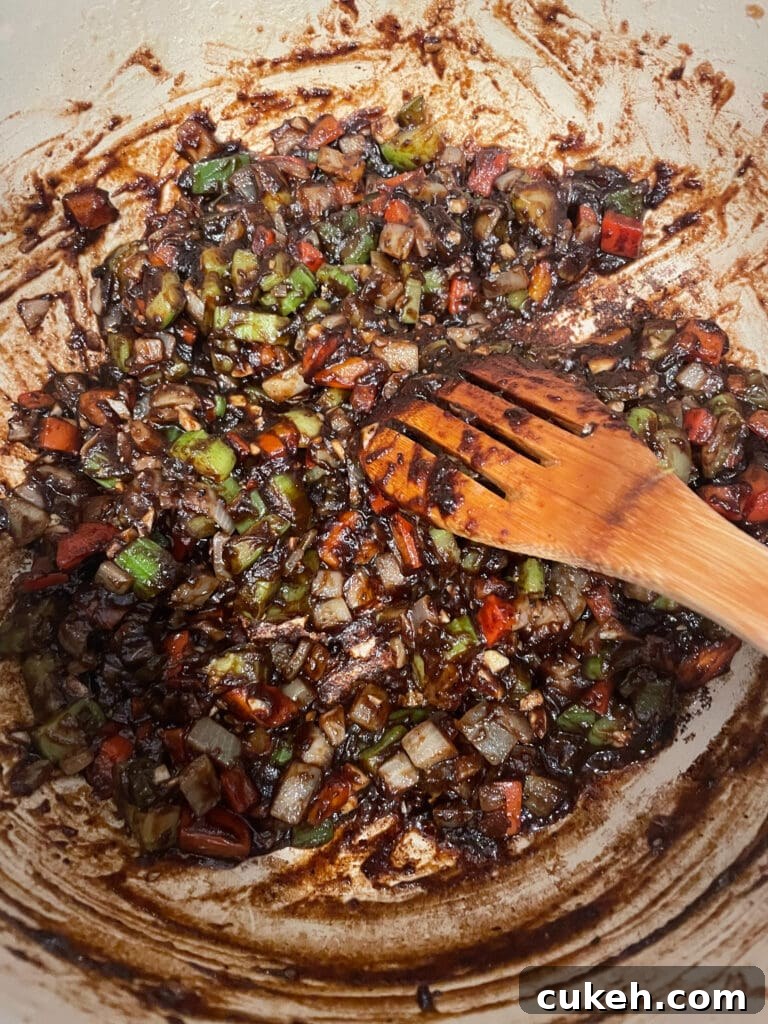 overhead shot of roux with chopped vegetables softened for gumbo