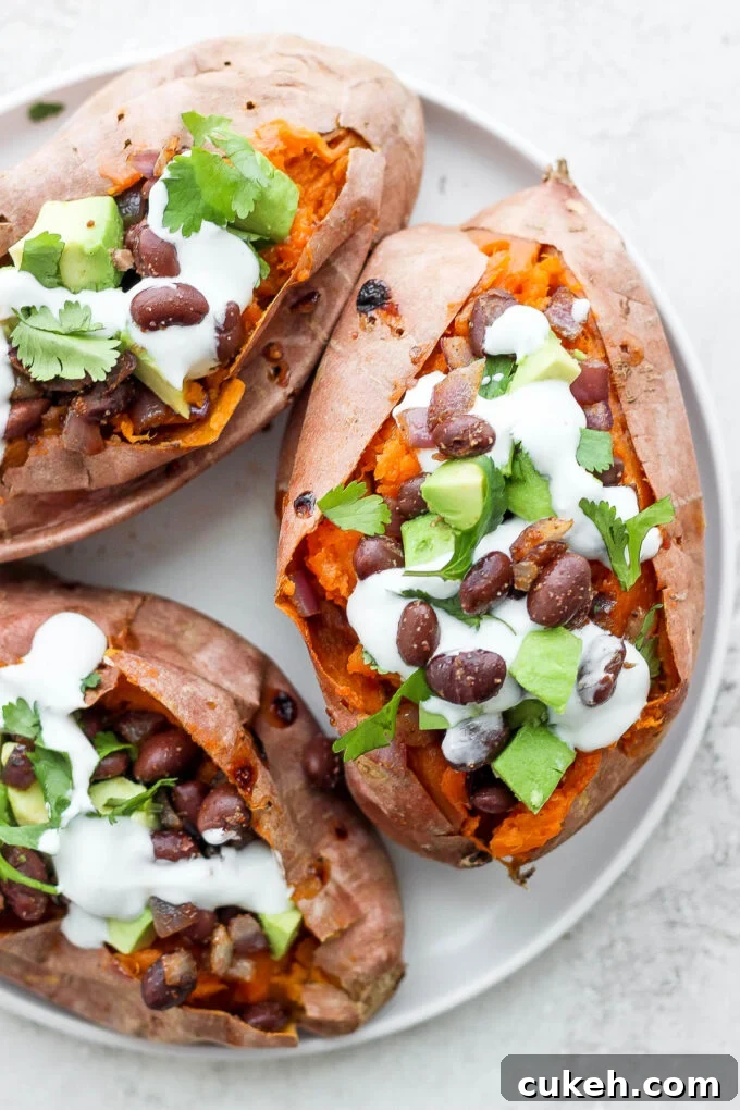 sweet potatoes stuffed with black beans, and avocado and topped with crema