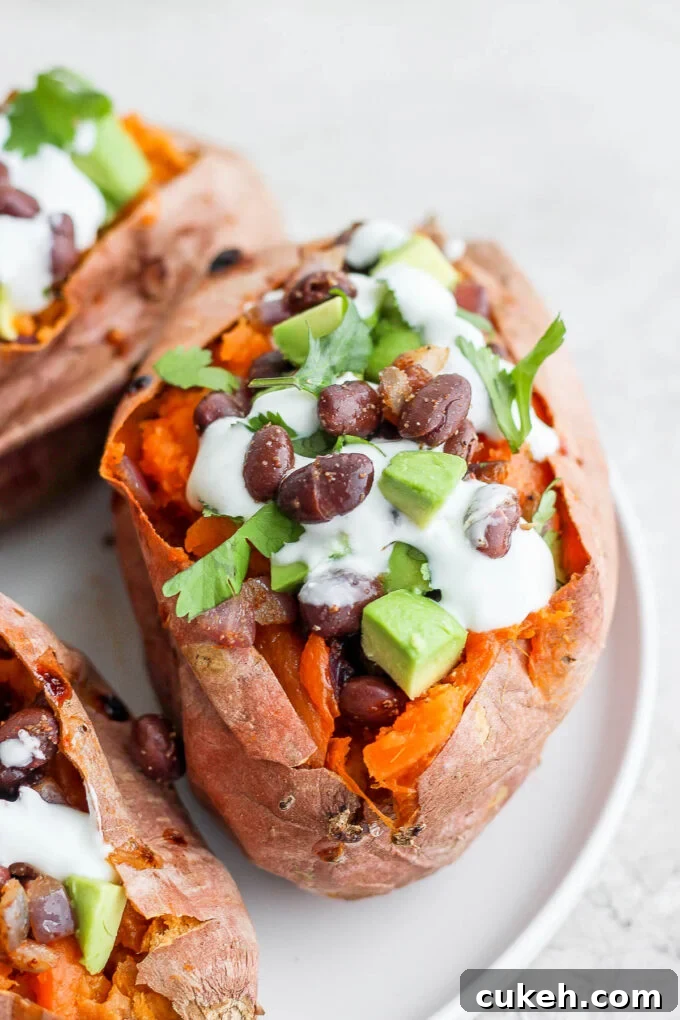 sweet potatoes stuffed with black beans, and avocado and topped with crema