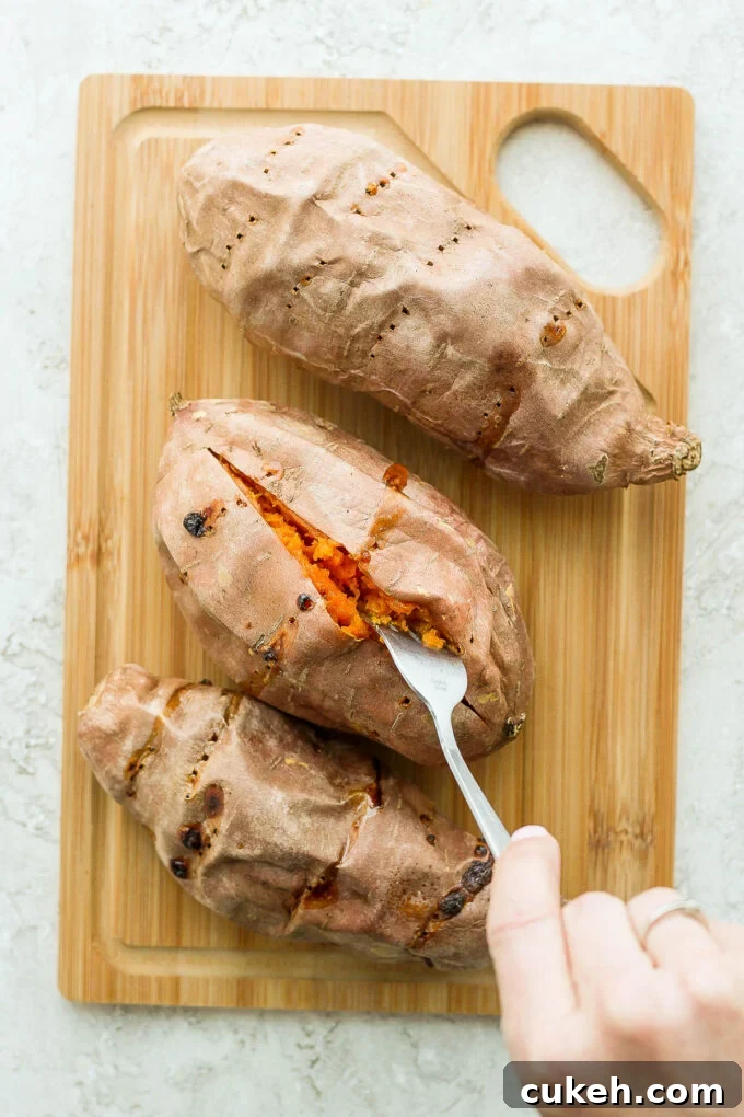 cooked sweet potatoes on a wooden board