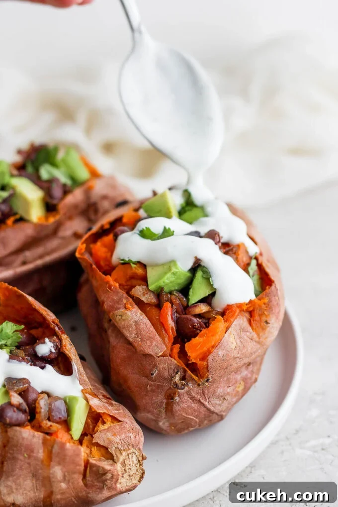 sweet potatoes stuffed with black beans, and avocado and topped with crema