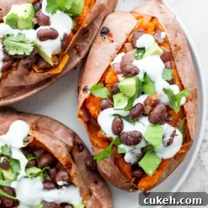 sweet potatoes stuffed with black beans, and avocado and topped with crema