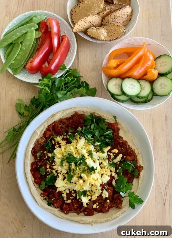 Hummus Shakshuka Snack Bowl with Veggies and Sweet Potato Chips via LizsHealthyTable.com 