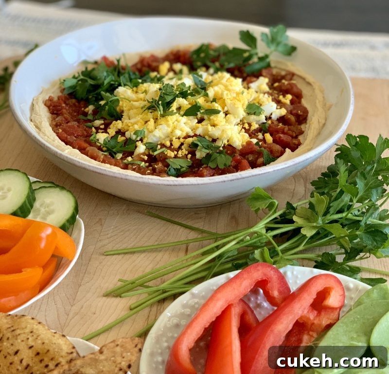 Hummus Shakshuka Snack Bowl with Veggies and Sweet Potato Chips via LizsHealthyTable.com 