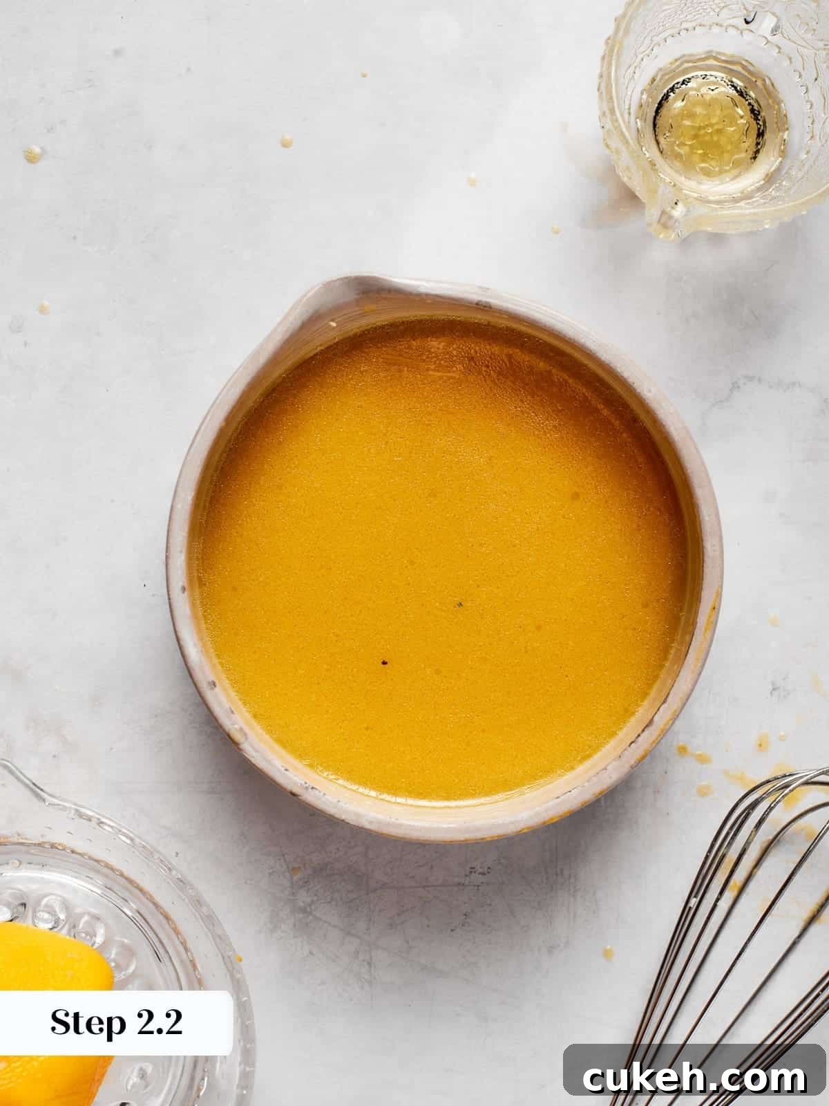 Smooth emulsified champagne vinaigrette showing a unified texture after whisking.