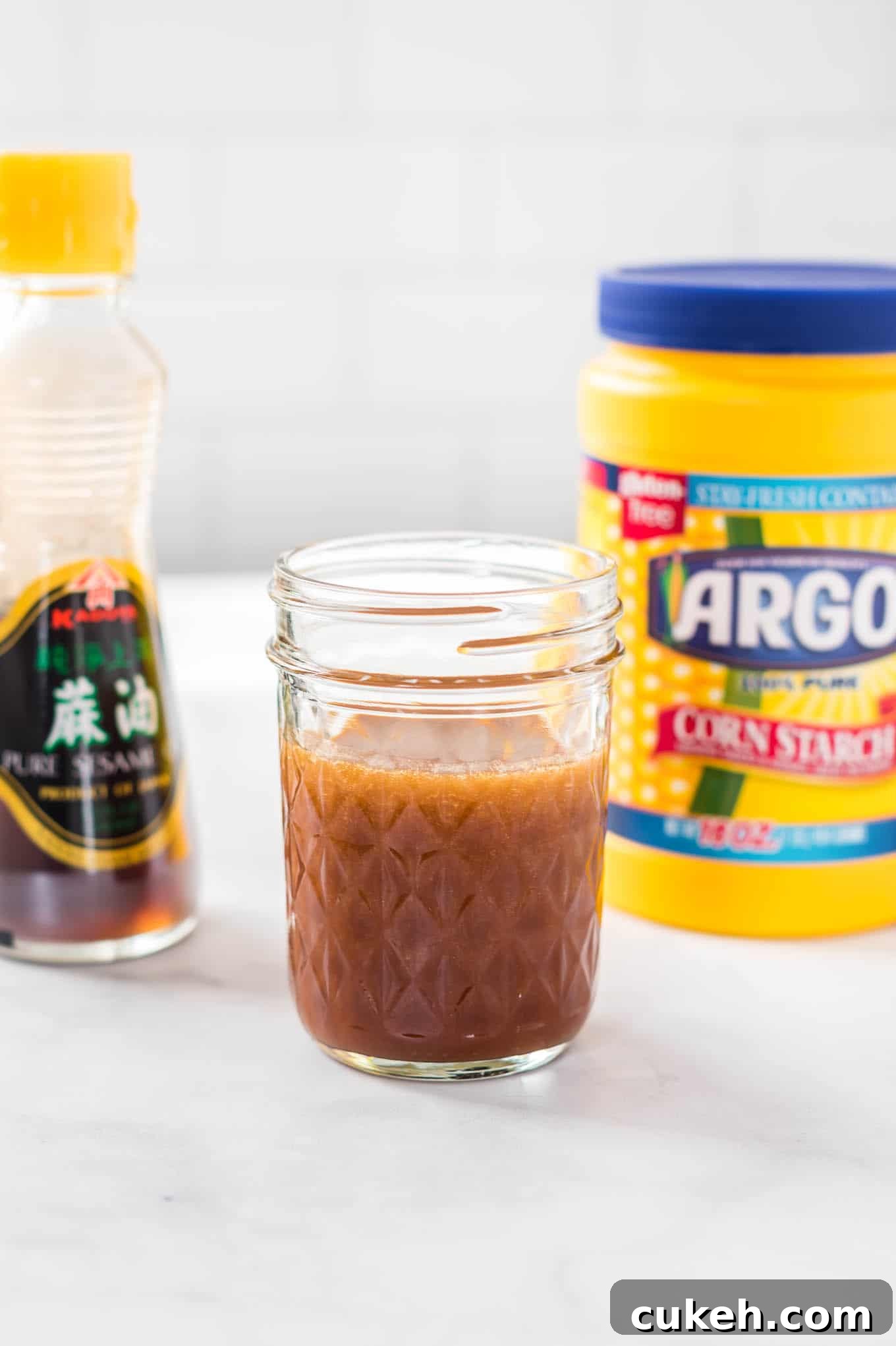 sauce in a jar with sesame oil and corn starch in the back ground
