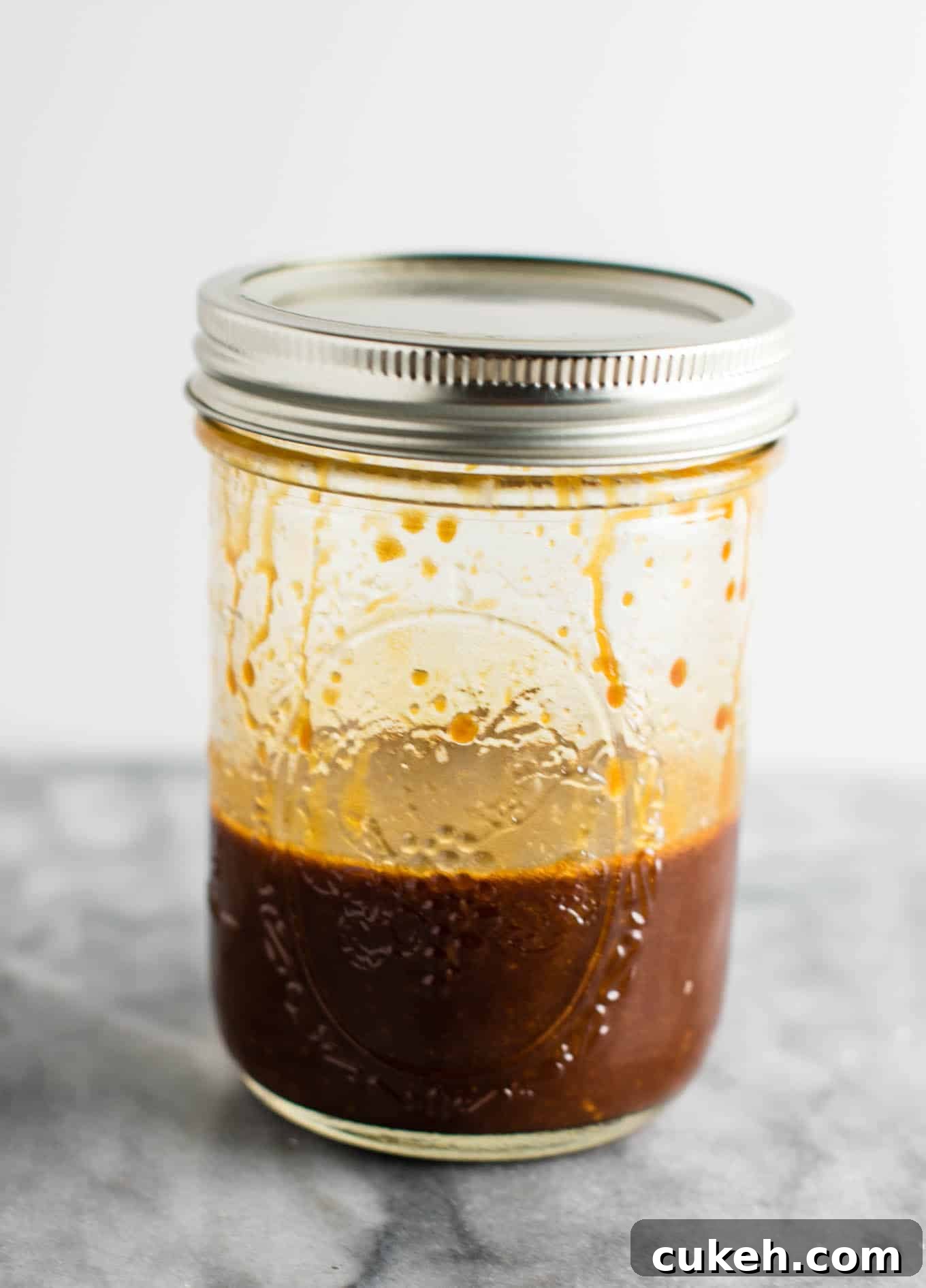 mason jar with shaken up stir fry sauce in it