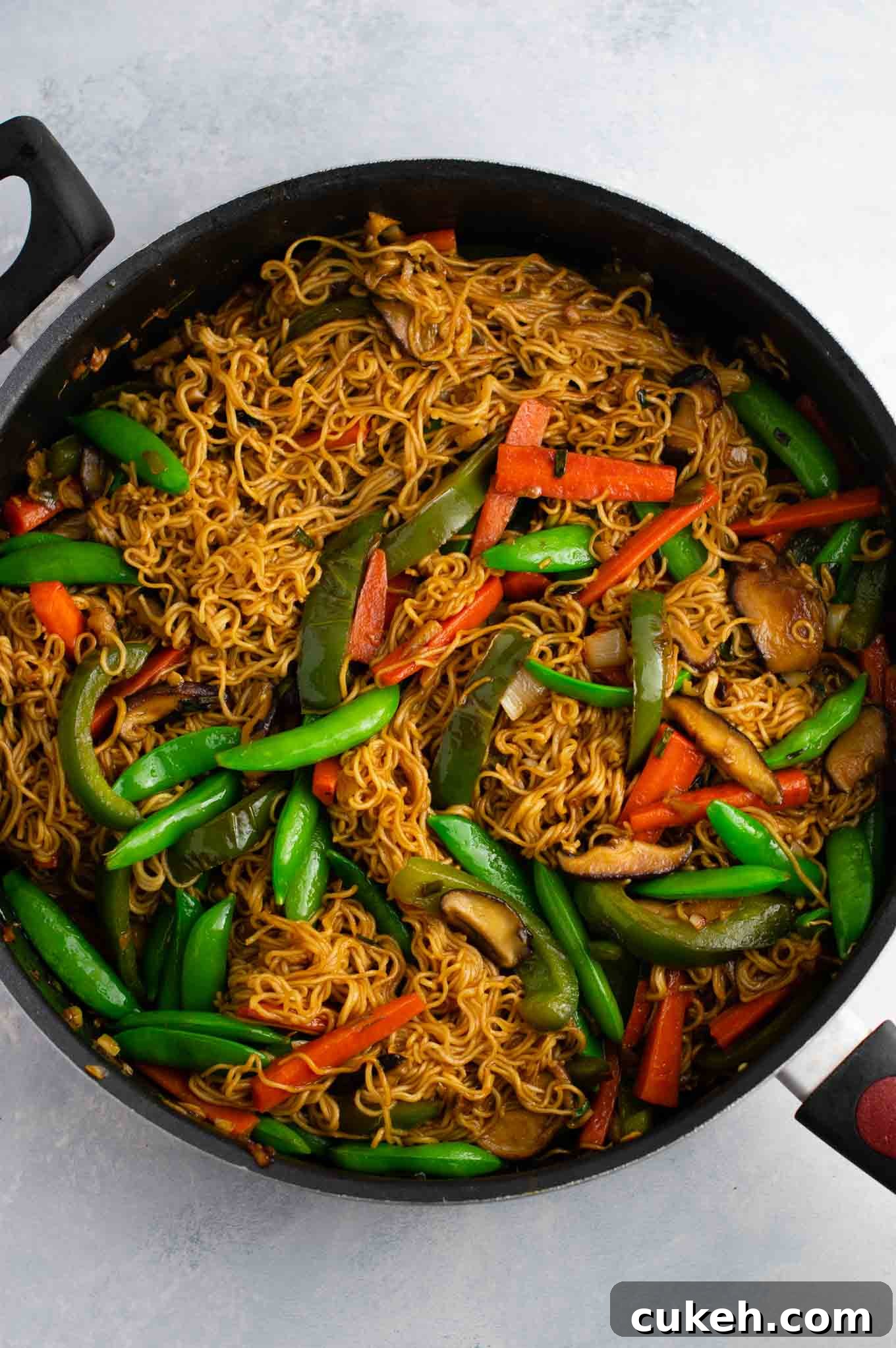 Ramen noodle stir fry with golden oak shitake mushrooms, sugar snap peas, green bell pepper, carrots, green onions, and fresh garlic and ginger.