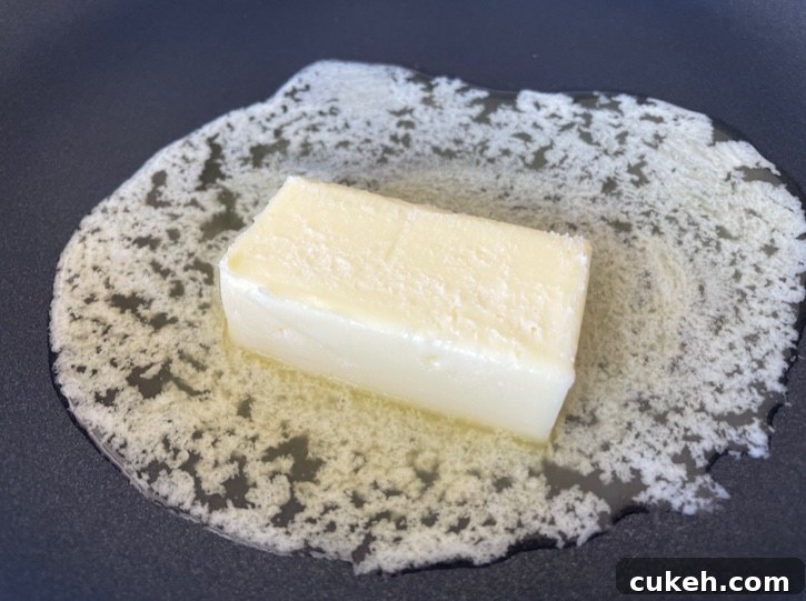 Butter melting in a pan for making Hot Buttered Cheerios. A delicious and easy snack idea for kids. 