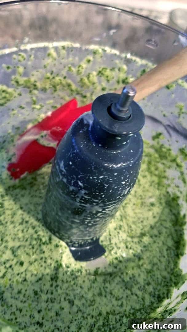 Mixing spicy Peruvian ahi verde sauce in food processor.
