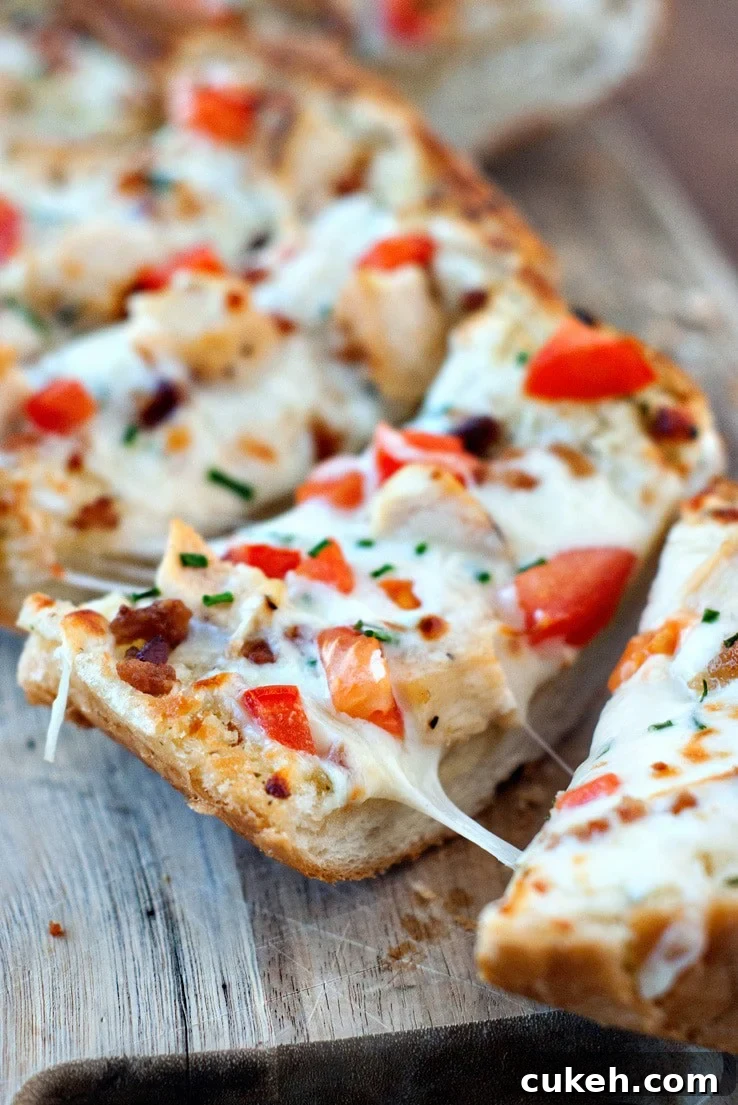 Splitting Chicken and Bacon Garlic Bread Pizza on a wooden board.