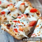 Simple Garlic Bread Pizza with mozzarella and tomatoes on a wooden board.