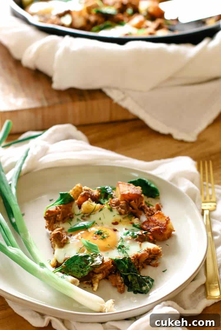 Healthy breakfast on a white plate with a cast iron in the background