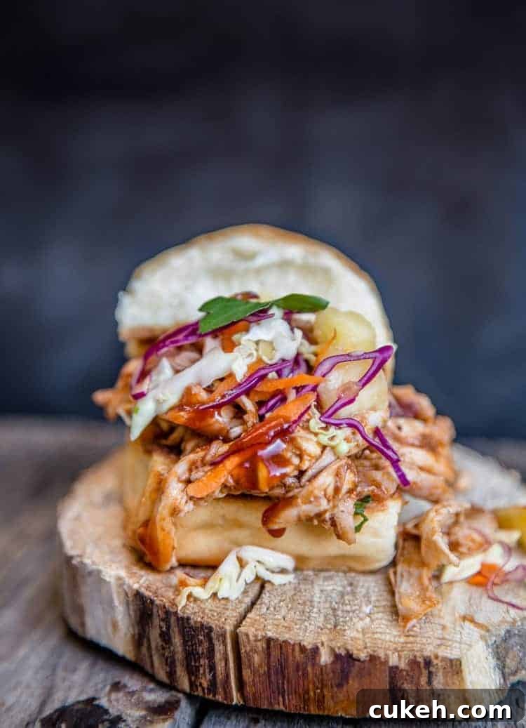 A pulled BBQ chicken slider using a Hawaiian style bun