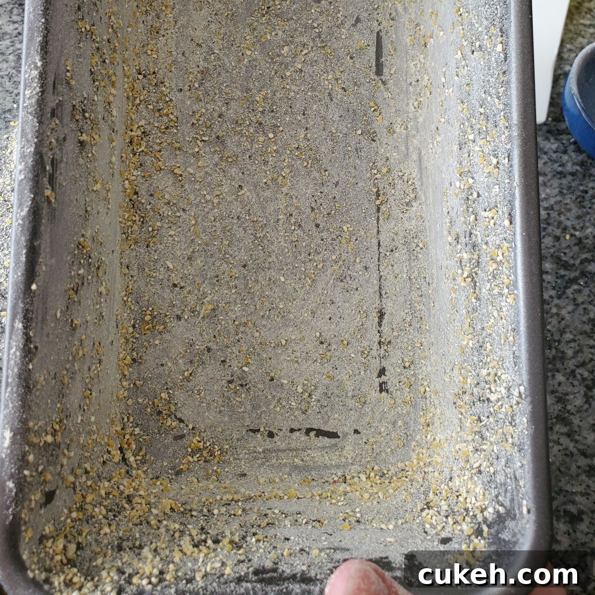 loaf pan coated in butter and then sprinkled with a dusting of cornmeal.