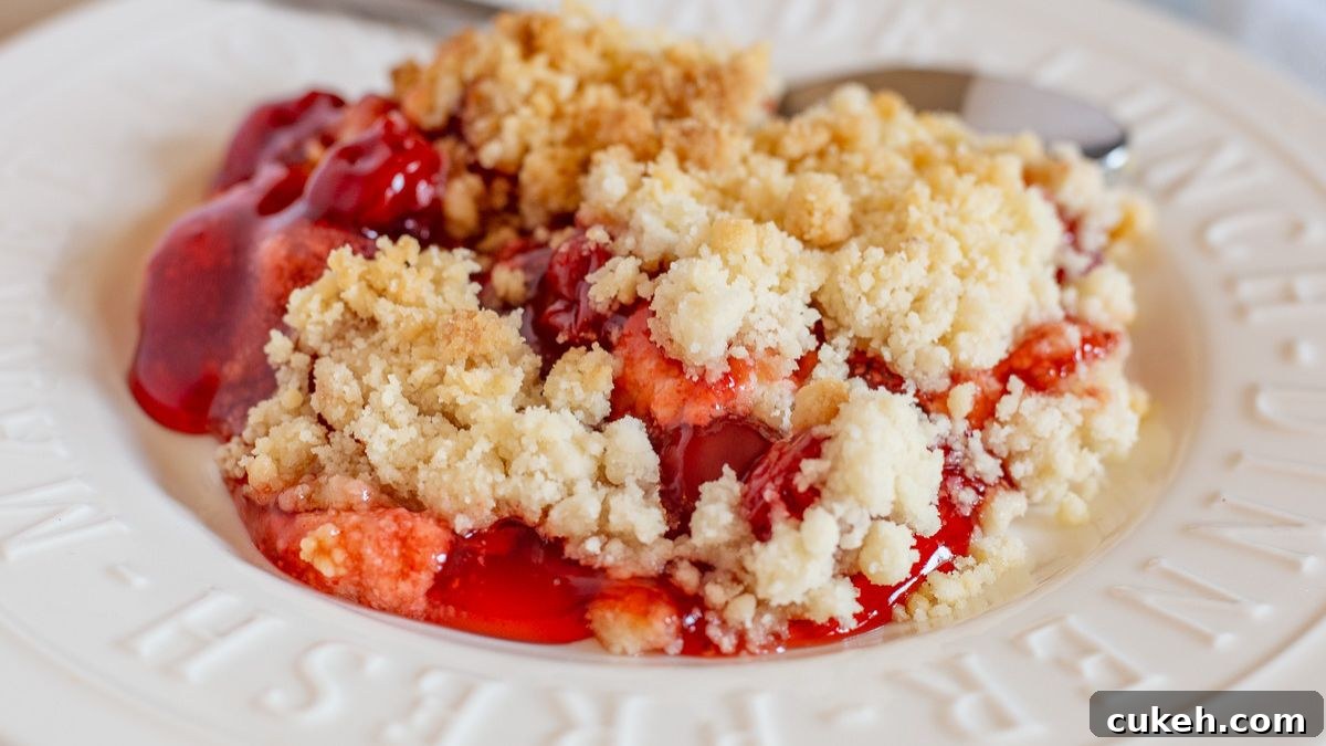 Cherry cheesecake dump cake served on a white plate.