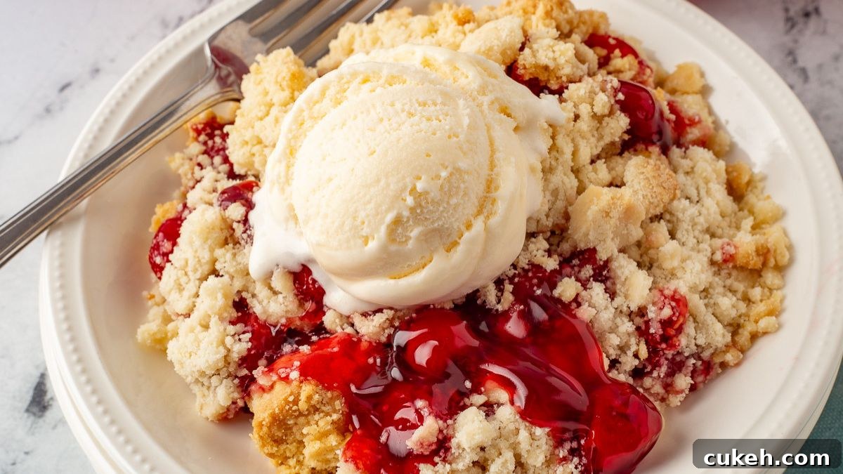 Cherry dump cake on a white plate.