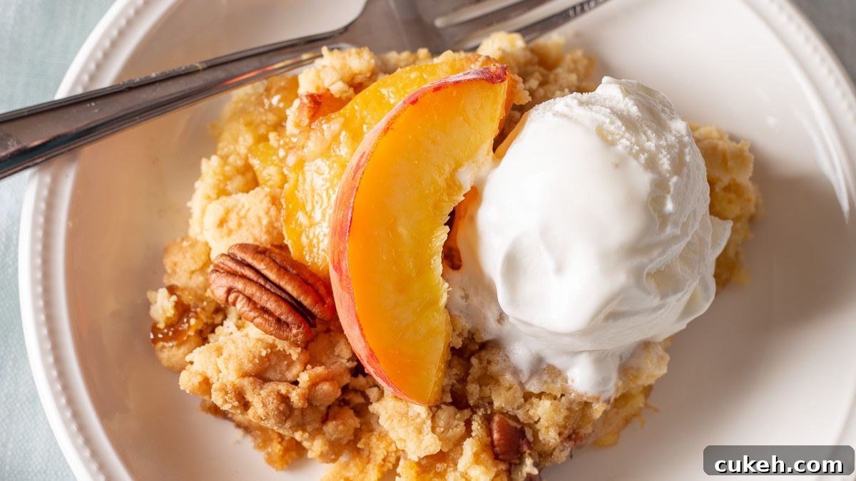 Fresh peach dump cake on a white plate.