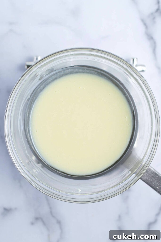melted white chocolate and cream in a bowl