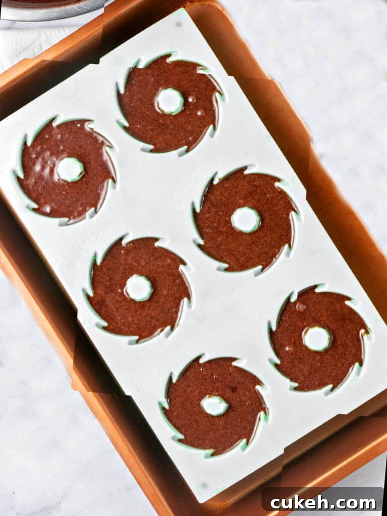 Mini Chocolate Bundt Cakes with Chocolate Glaze 6 Gray bundt cake pan with chocolate batter. Gray background.