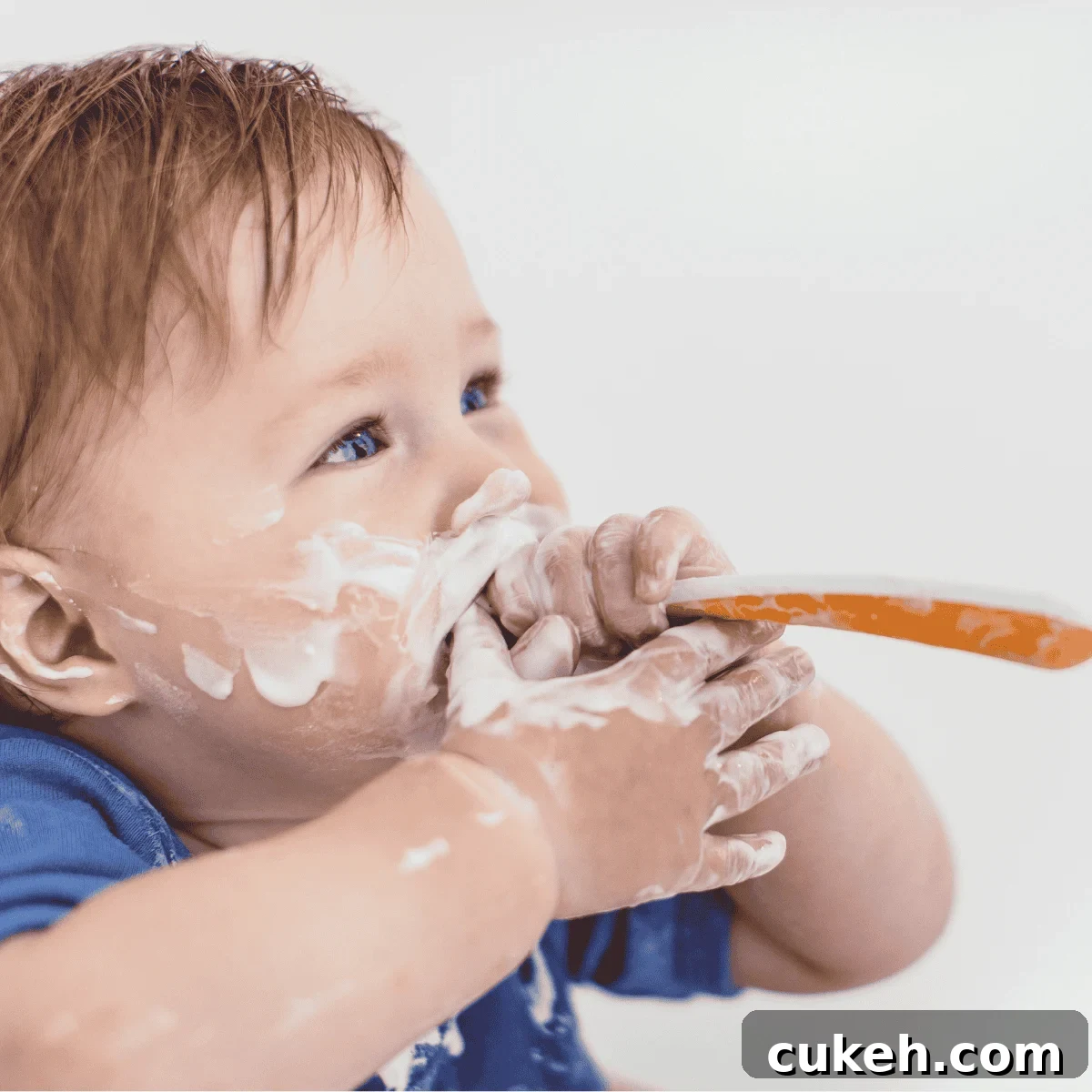 baby eating yogurt