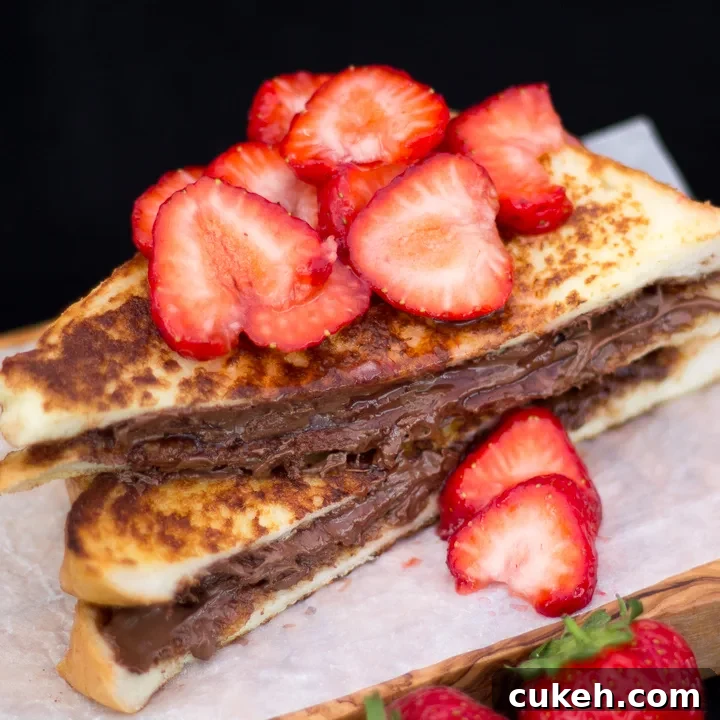 Strawberry Nutella French toast on a wooden board.