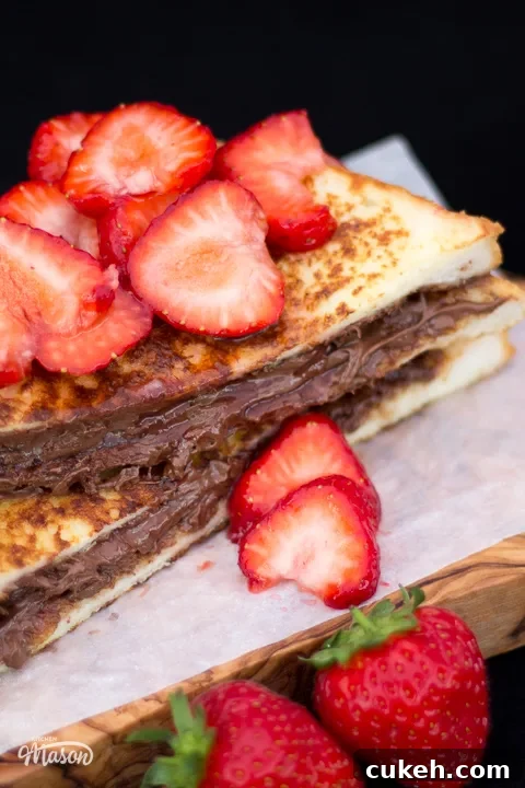 Nutella French toast sliced in half and topped with strawberries.