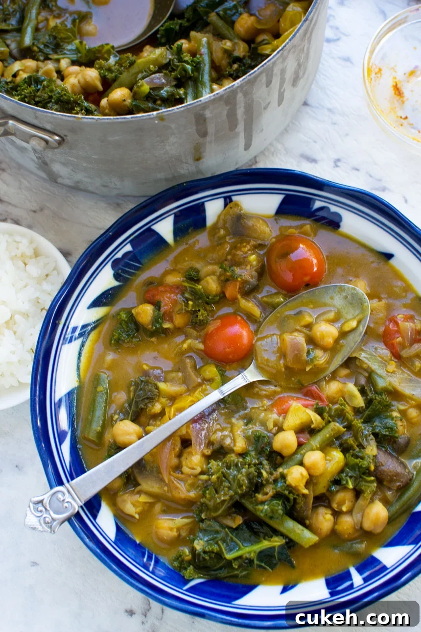 20-Minute Coconut Chickpea Curry with Spinach and Tomato 5 A 20-minute coconut chickpea curry with a spoon in it from above
