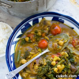 20-Minute Coconut Chickpea Curry with Spinach and Tomato 7 A 20-minute coconut chickpea curry with a spoon in it from above