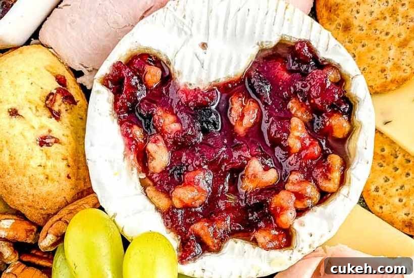 Thanksgiving Charcuterie Board Ideas for a Festive Spread 4 Close-up view of the cranberry brie wheel placed on the charcuterie board.