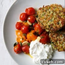 Zucchini and Barley Cakes with Roasted Cherry Tomatoes & Ricotta 6 Zucchini barley cakes, roasted cherry tomatoes and ricotta cheese on a a plate