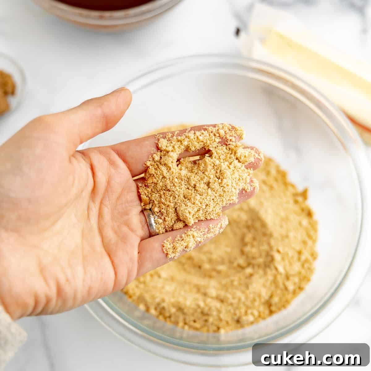 Graham cracker crumbs in a hand.