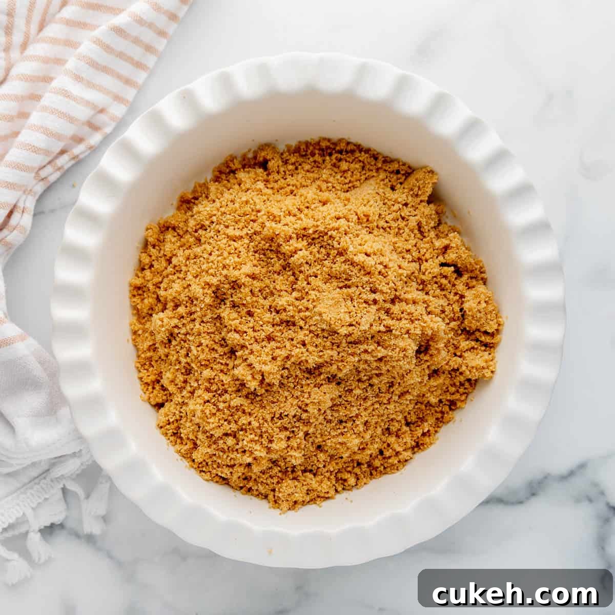Graham cracker crumbs in a pie plate.