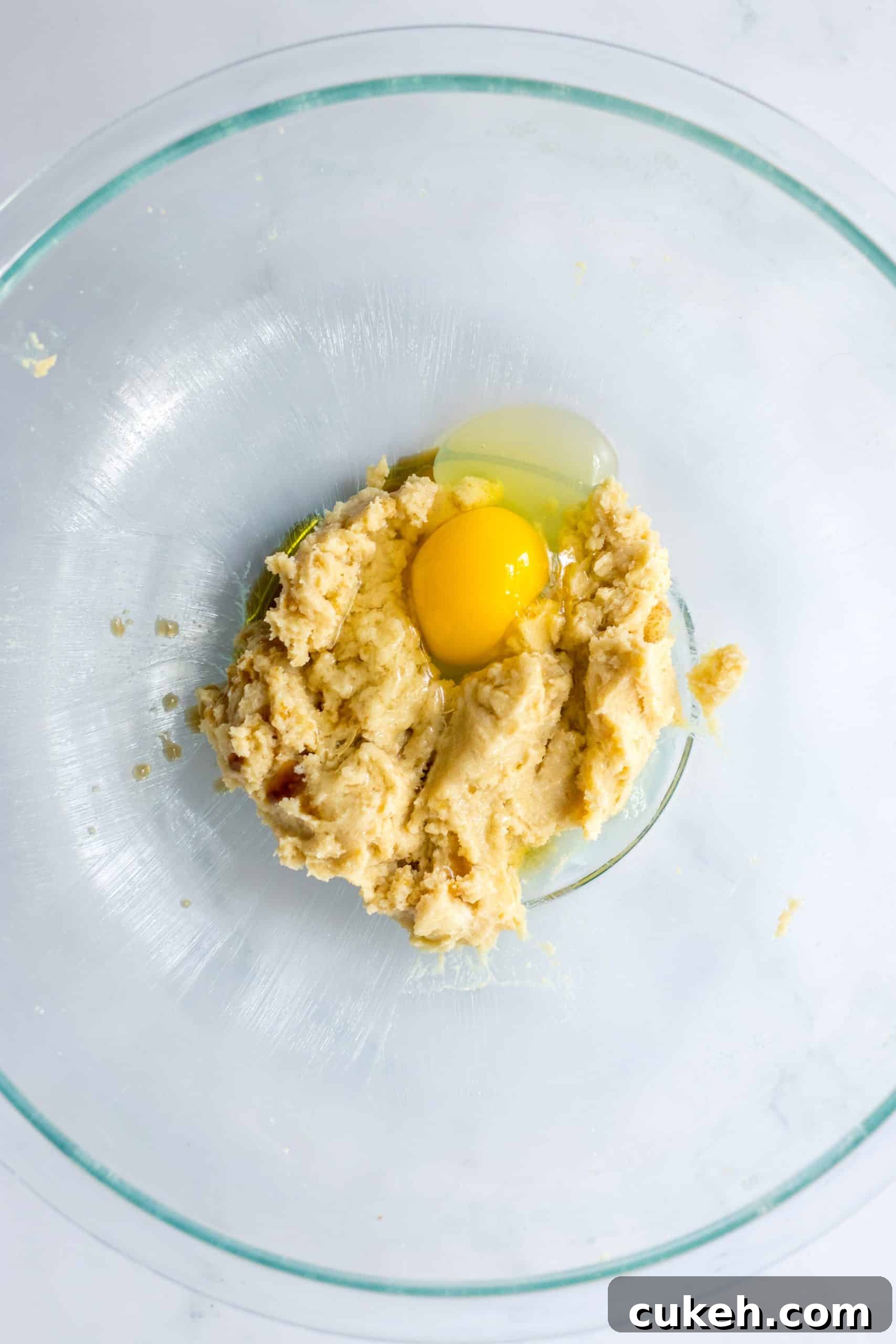 egg and creamed butter in a glass mixing bowl
