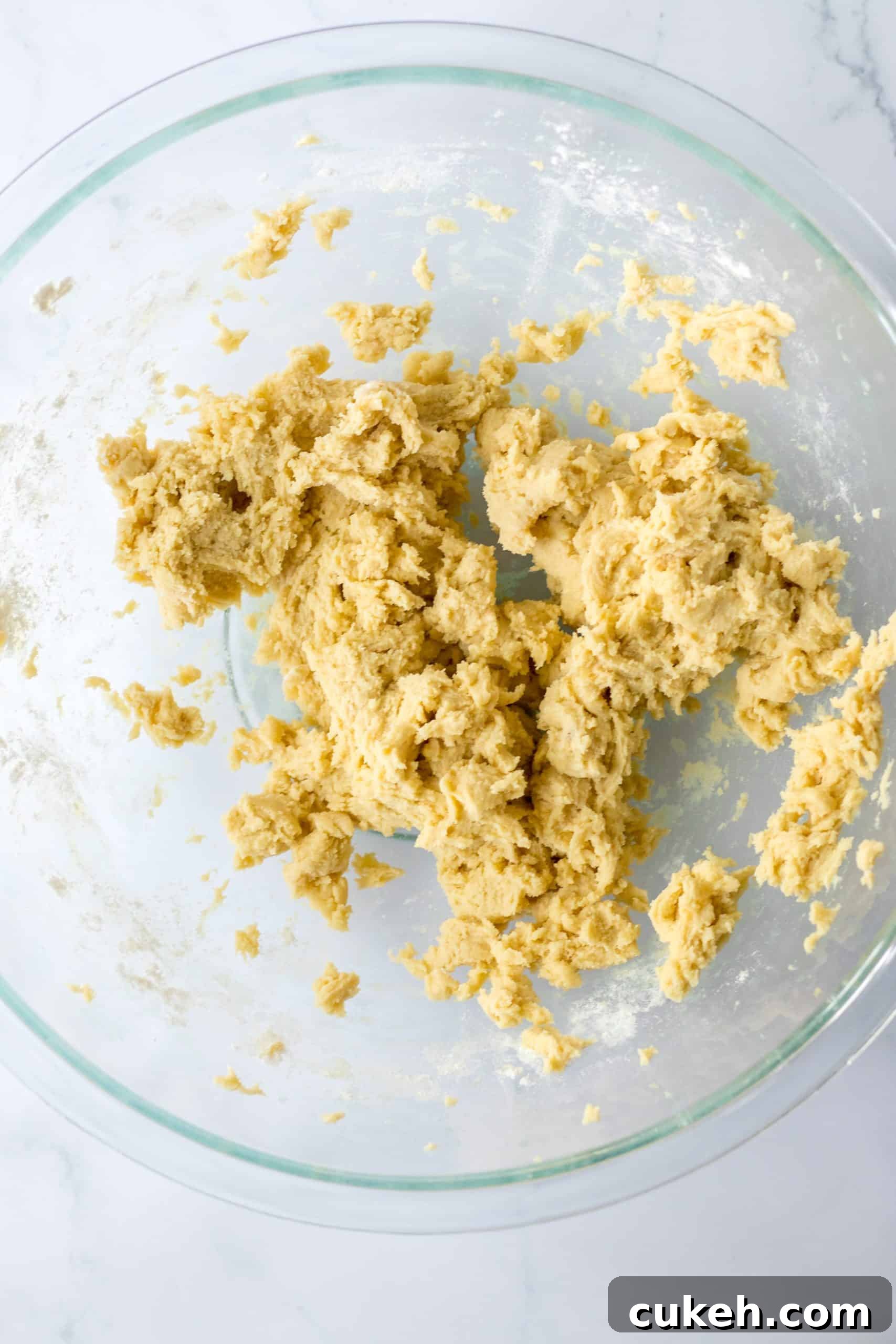 cookie dough in a glass mixing bowl