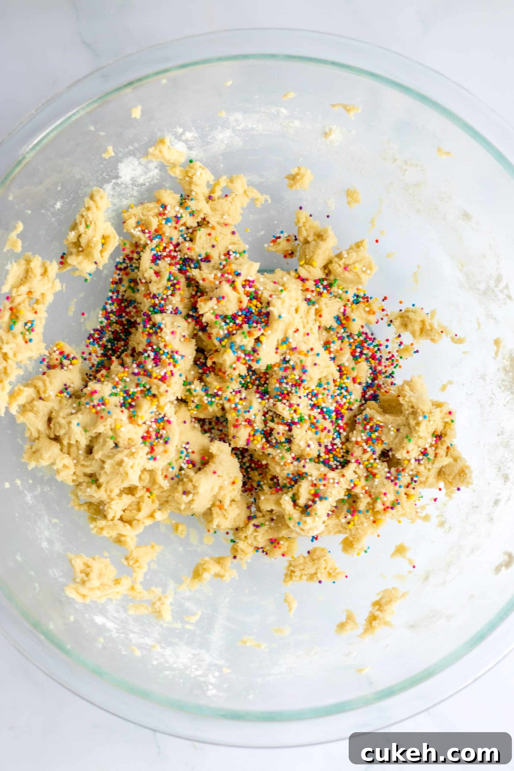 sprinkled cookie dough in a glass mixing bowl